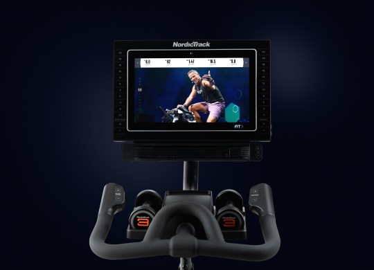 Upper half of bike shown including the screen with iFIT trainer as well as weights handlebars and some frame.