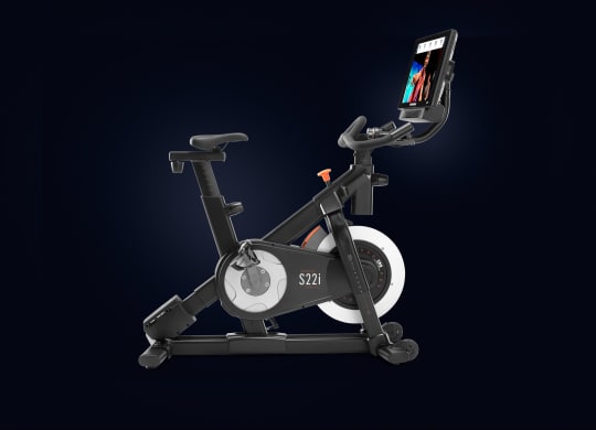 Upper half of bike shown including the screen with iFIT trainer as well as weights handlebars and some frame.
