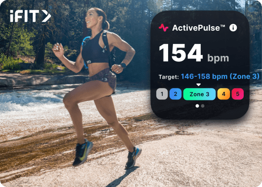 iFIT trainer running outdoors through the forest