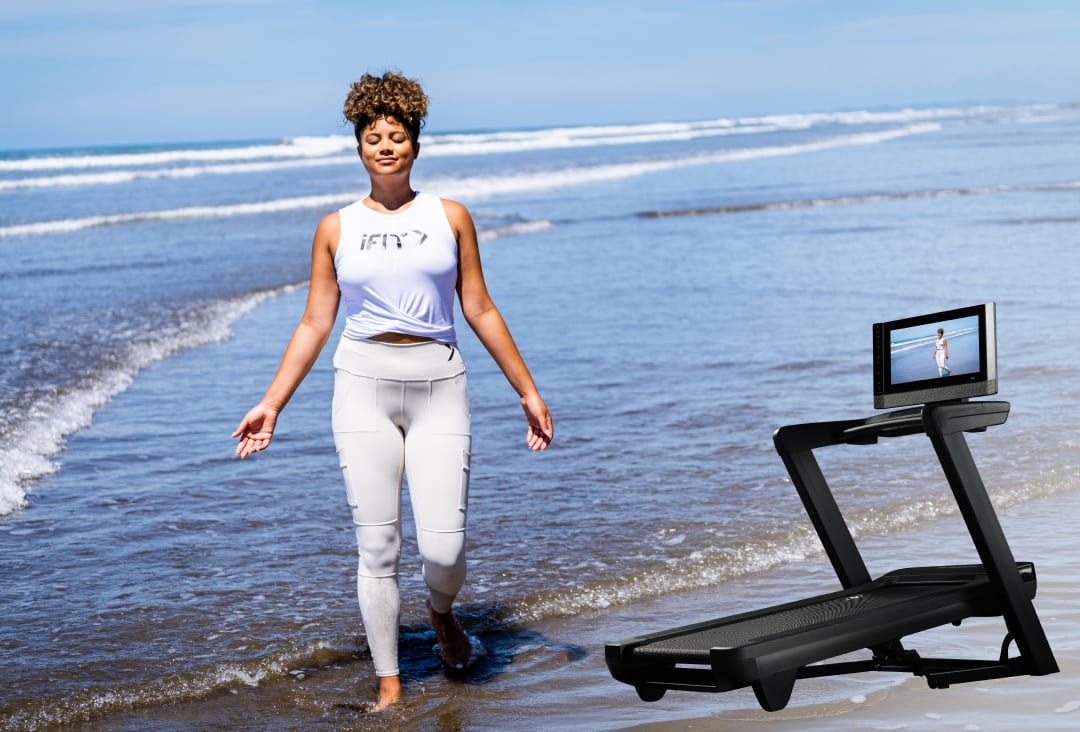 ifit trainer walking on a beach