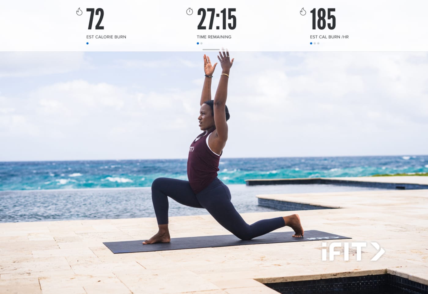 Woman doing yoga on a mat on the beach