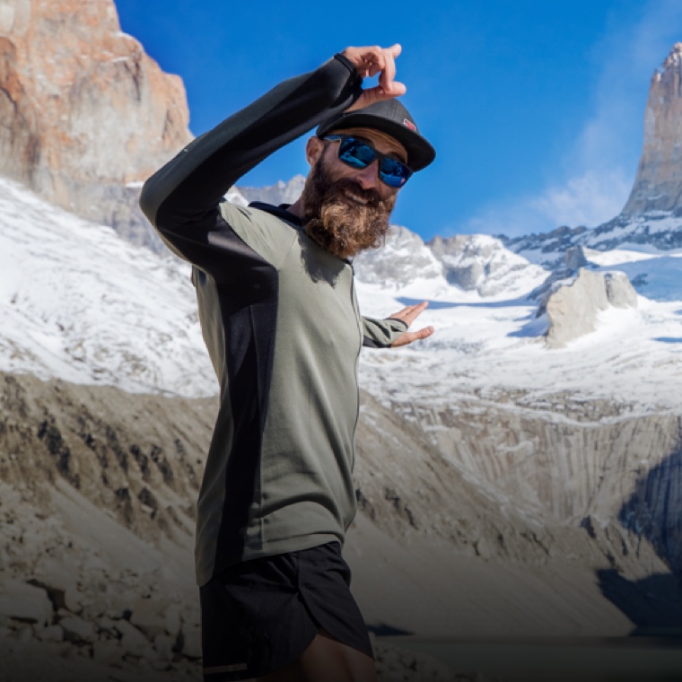 River Puzey smiling while running the snow-capped mountains of Patagonia