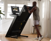 man folding his nordictrack treadmill
