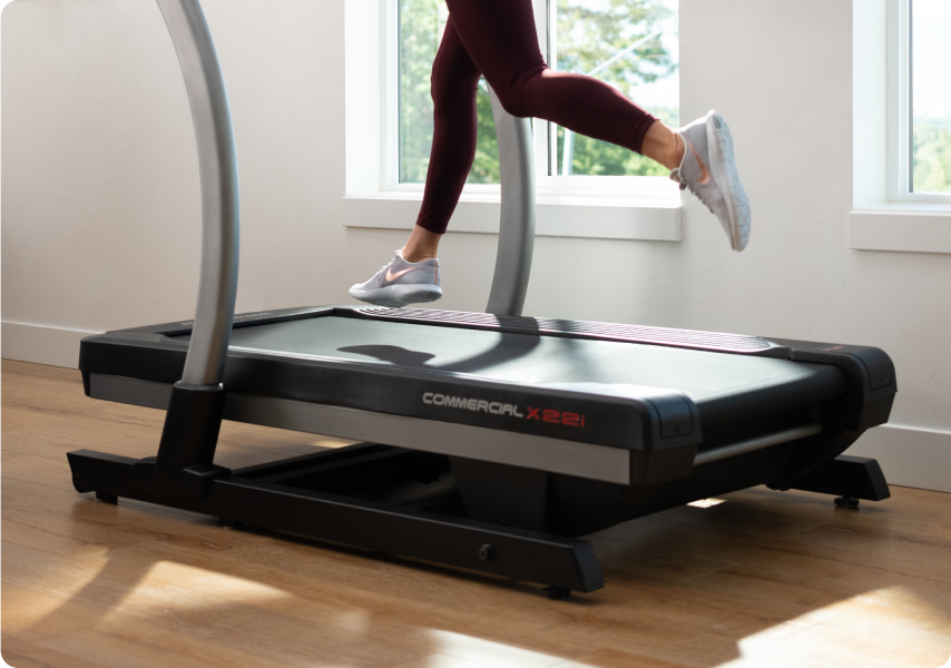woman running on a nordictrack treadmill in her home