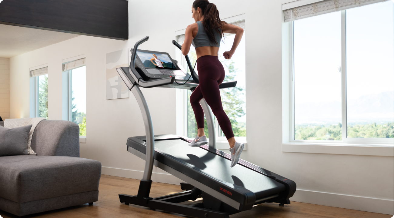 woman running on her nordictrack incline trainer in her home