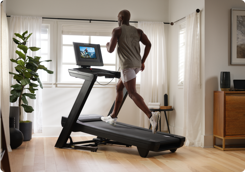 Man running on a treadmill with an incline.