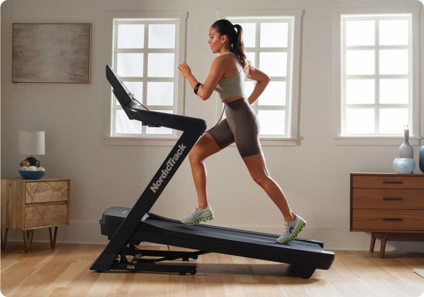 Woman running on a treadmill with an incline.