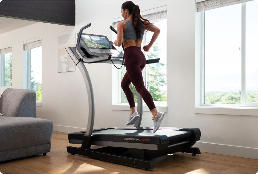 woman running on a nordictrack incline treadmill