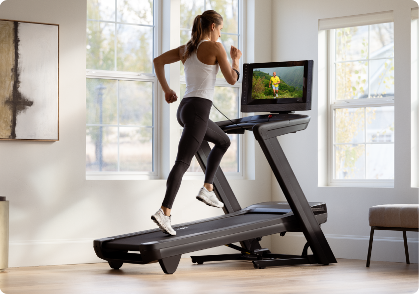 Woman running on a treadmill with an incline.
