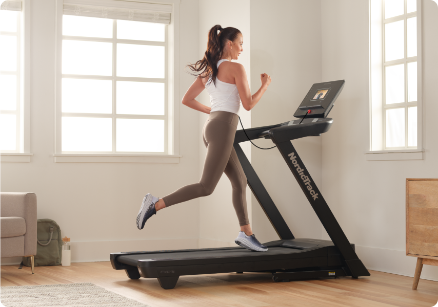 Woman running on a NordicTrack treadmill.