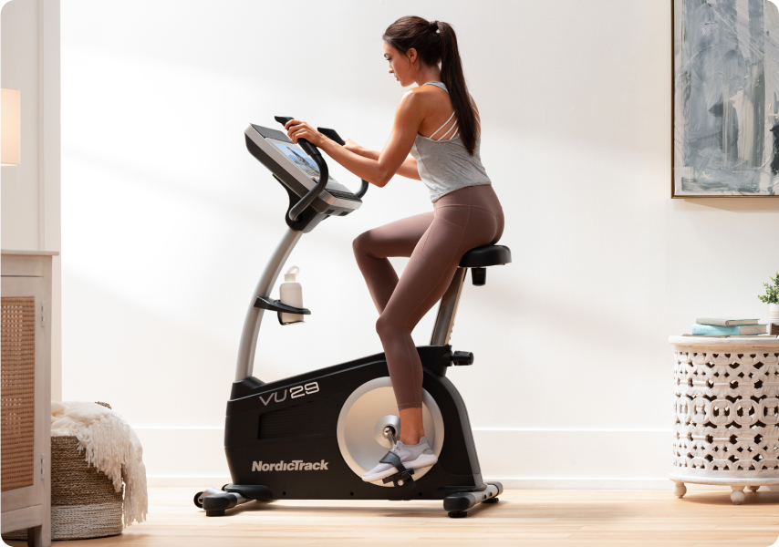 Woman riding a NordicTrack upright stationary bike.