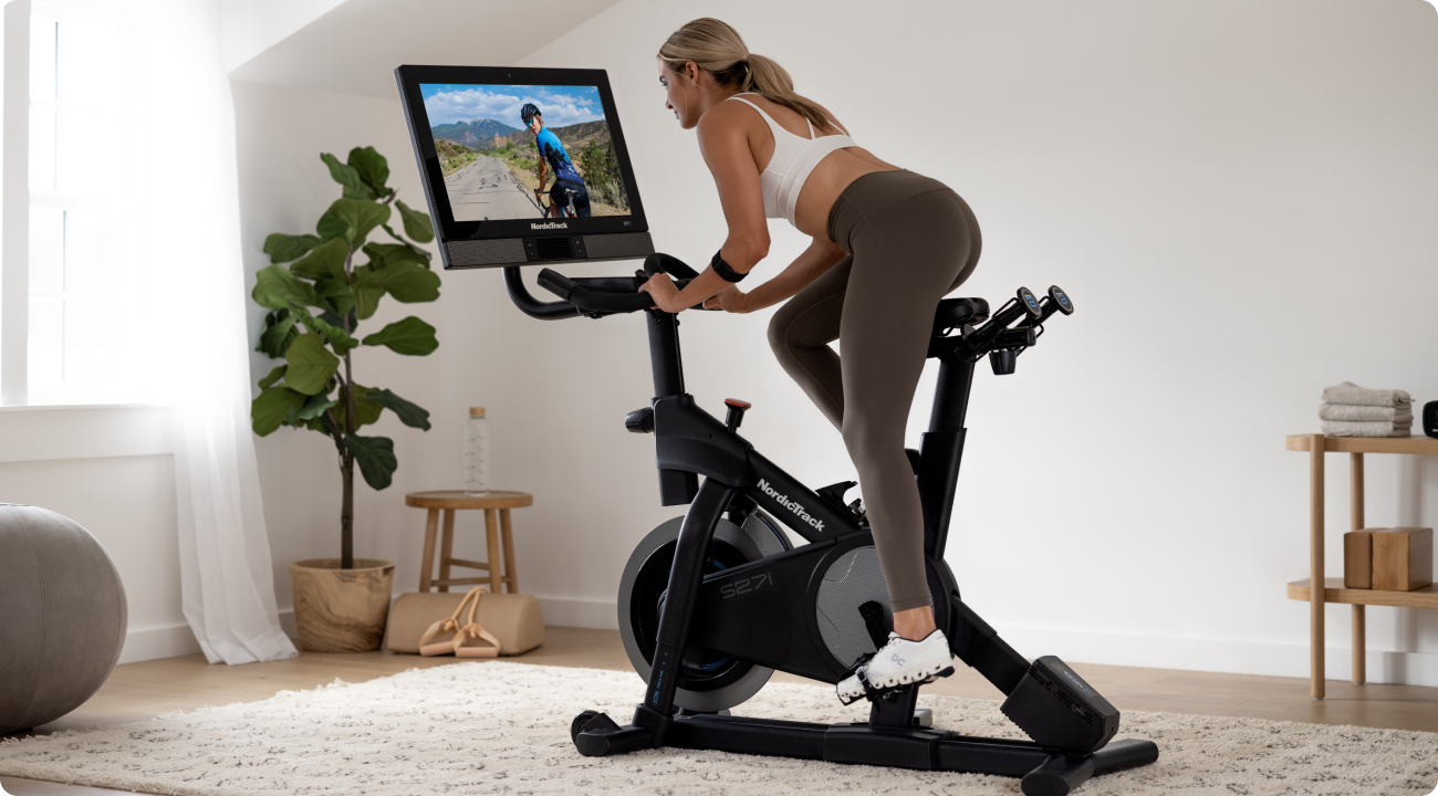 Woman riding a NordicTrack exercise bike on a decline.