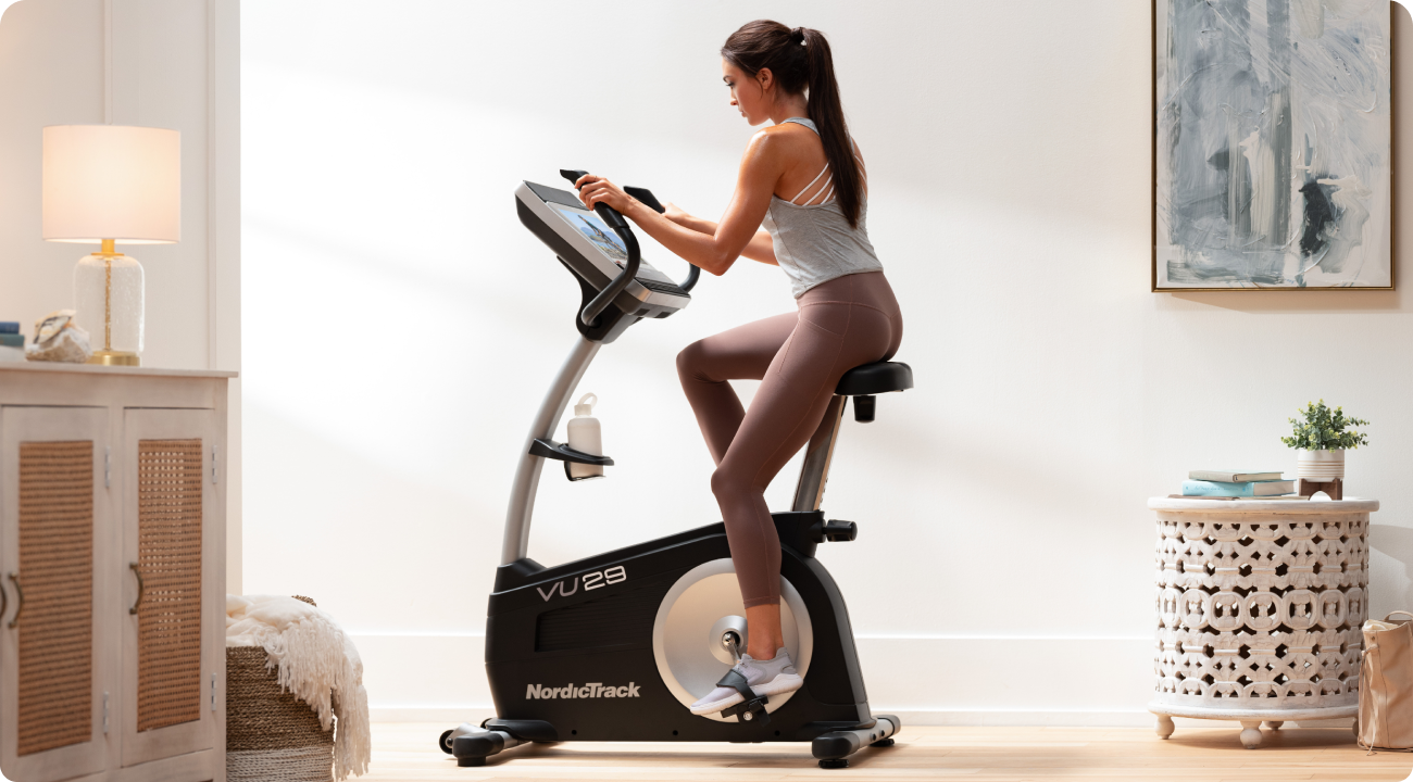 Woman riding the Commercial VU 29 upright stationary bike.