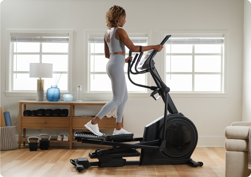 Woman working out on a NordicTrack elliptical.